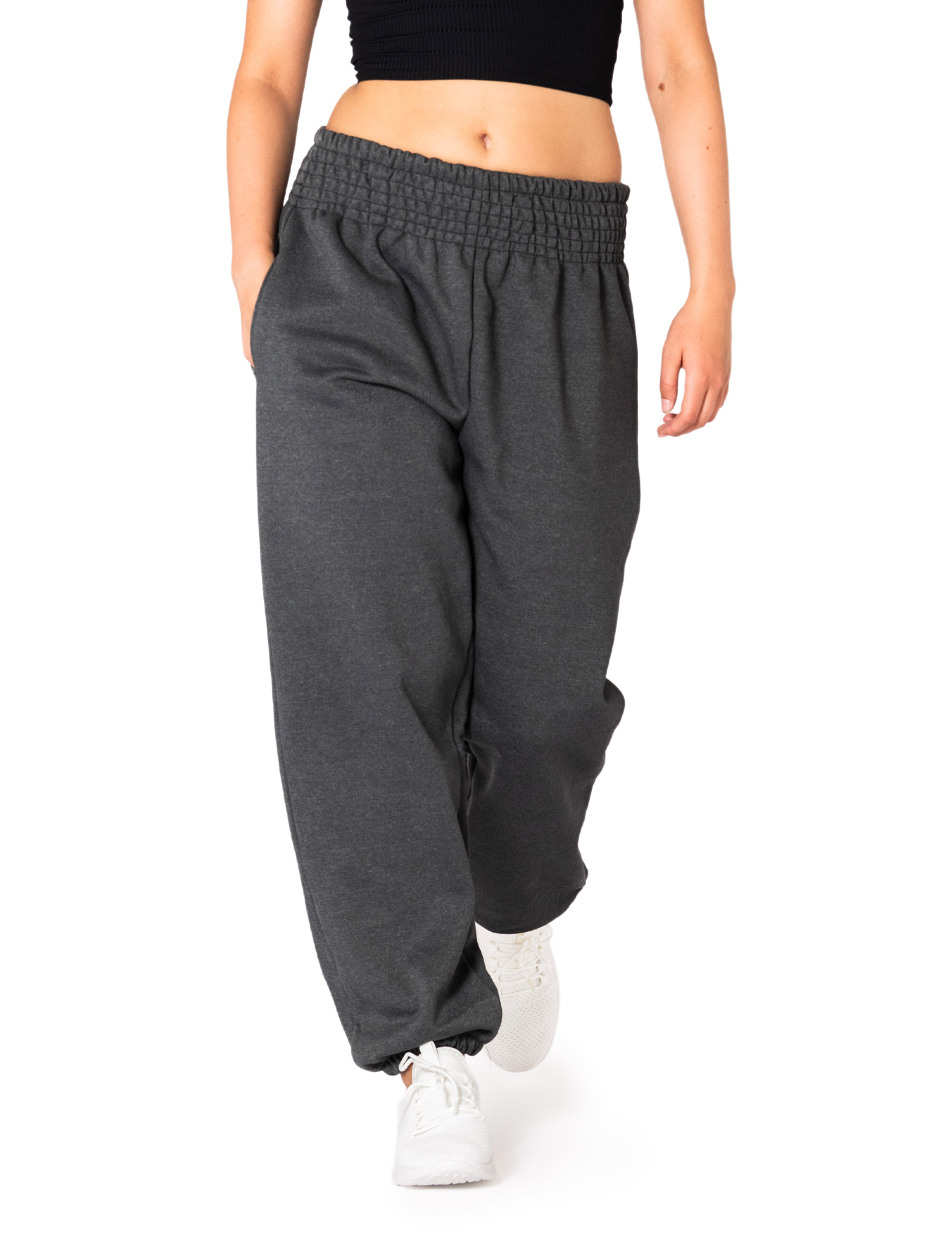 Model wearing PANASIAM women's joggers in 100% cotton, anthracite, with a high smocked waistband, loose fit and elastic cuffs