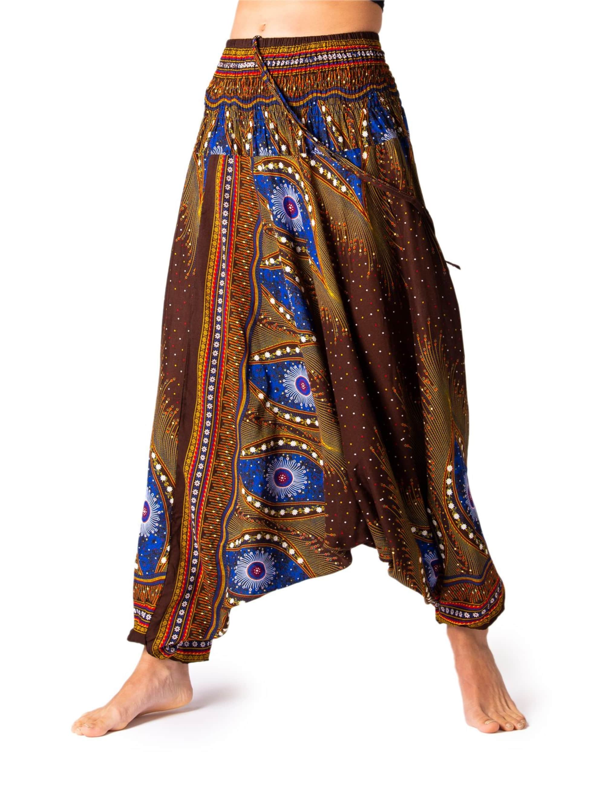 Model trägt die PANASIAM Aladinhose Peacock mit blau-braunem Pfauenmuster, weiter Haremsschnitt, luftig und bequem für Yoga, Tanz und Freizeit.