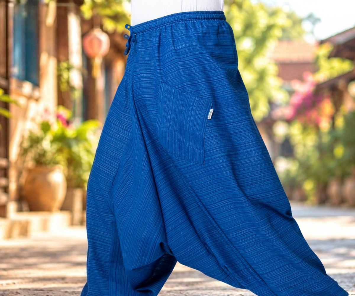 Close-up of blue harem trousers with a wide leg, elasticated waistband and side pockets